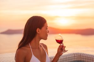 Luxury-vacation-woman-drinking-red-wine-glass-in-private-pool-at-luxury-hotel-destination